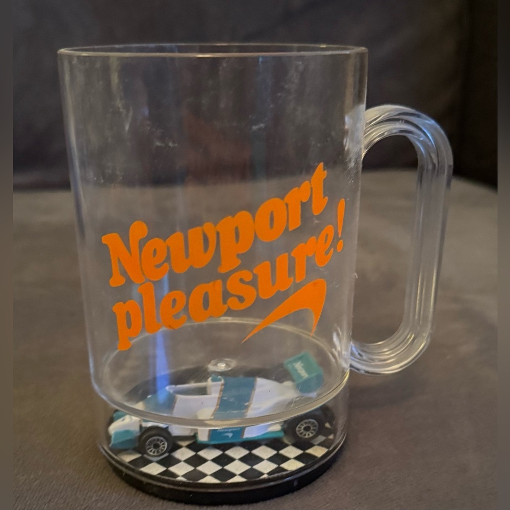 Newport Pleasure Clear Plastic Mug with Race Car in Bottom.